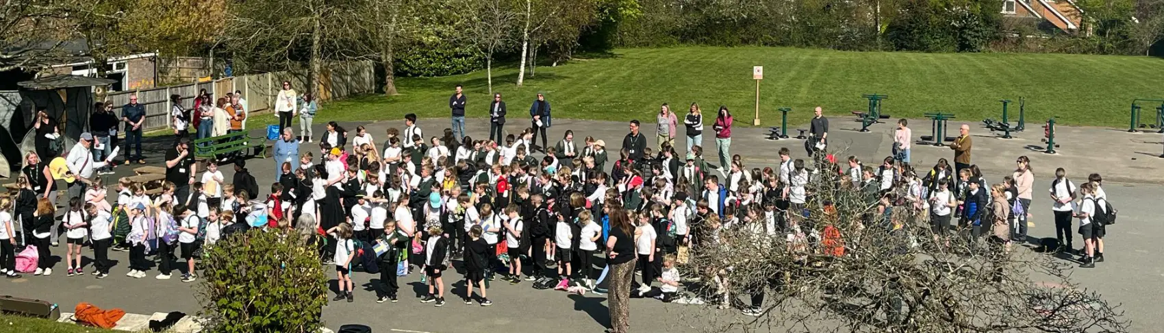 Lots of people standing in the playground at St Anne's CE Primary school