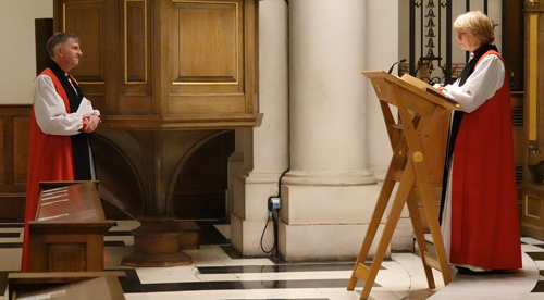 Bishop Hugh stands in front of Bishop Sarah Mullally as she delivers her 'charge' to him.