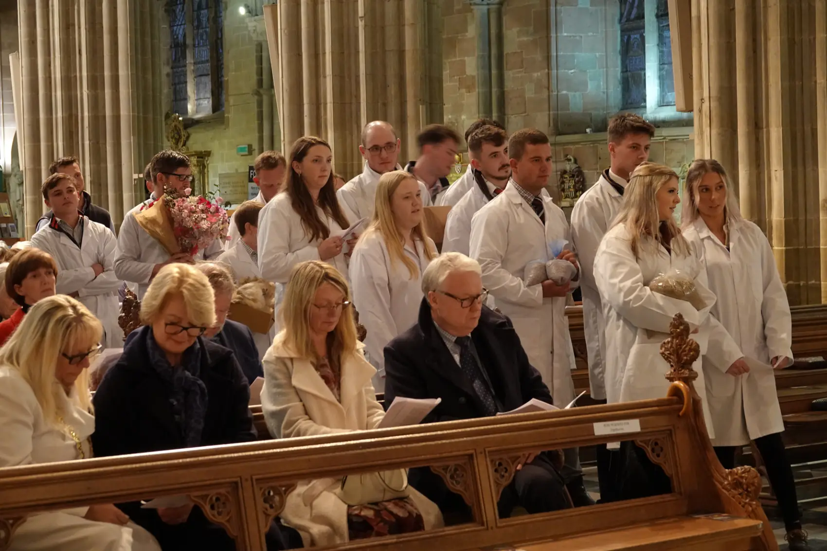 Young farmers bringing up gifts at the front of the cathedral