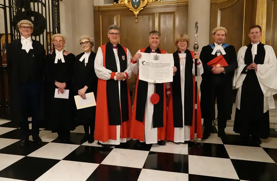 Bishop Hugh holds the document from the King confirming him as Bishop of Worcester surrounded by others who took part in the confirmation of election service
