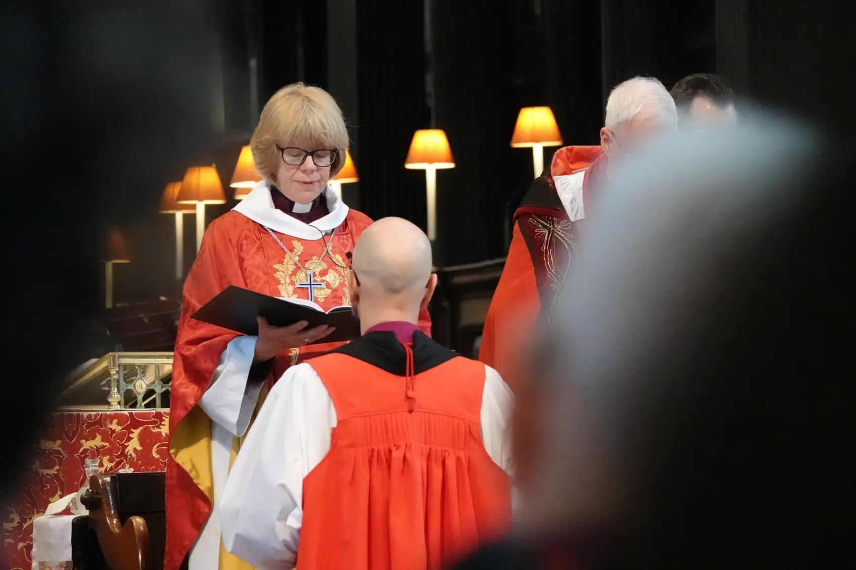 James Treasure kneeing in front of Archbishop Sarah
