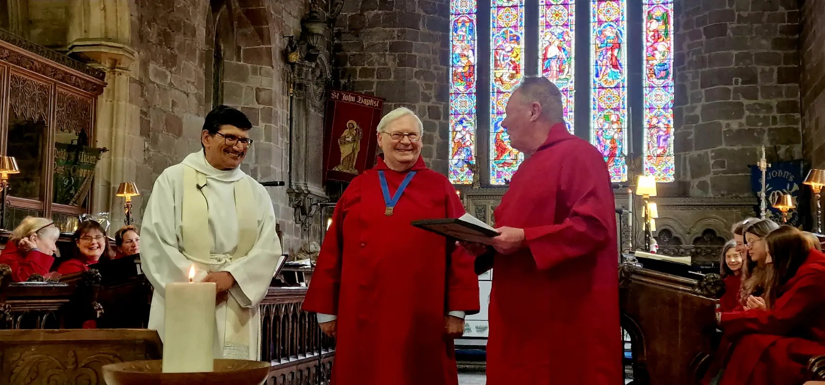 Dave Banner standing at the front of St John's Church as he's presented with a RSCM long service certificate