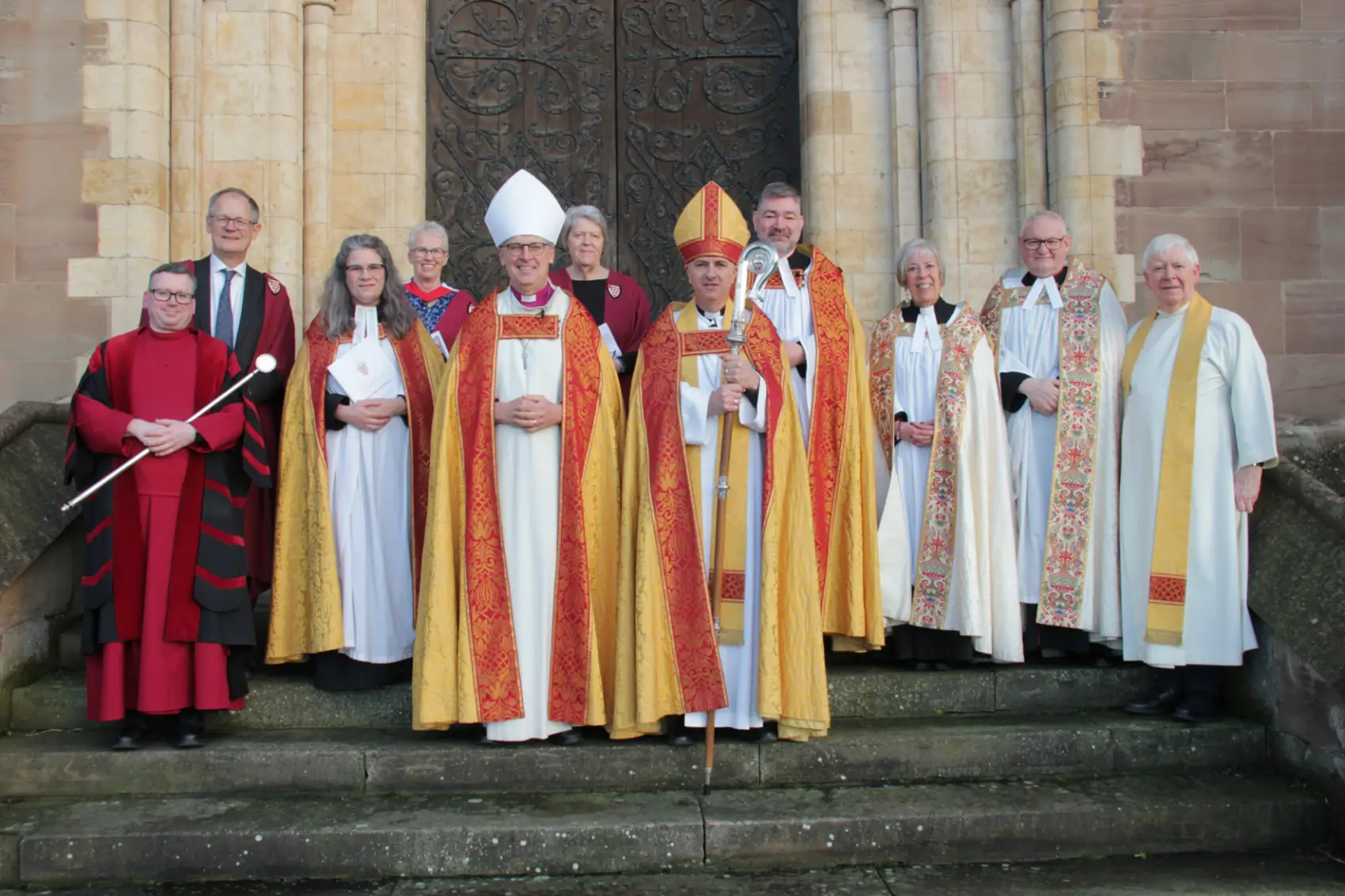 Bishops Hugh and Martin standing with the Cathedral Chapter and Archdeacons
