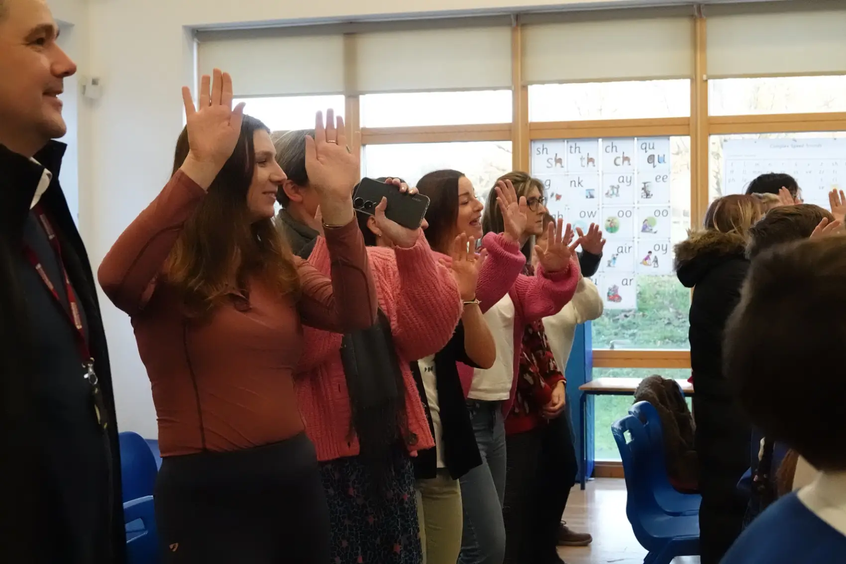 A line of parents joining in with dance moves