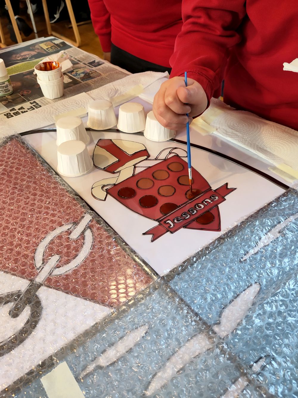 A pupil takes part in a painting activity