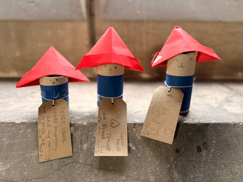 Mini paddington bears made out of a toilet roll with a cardboard red hat on