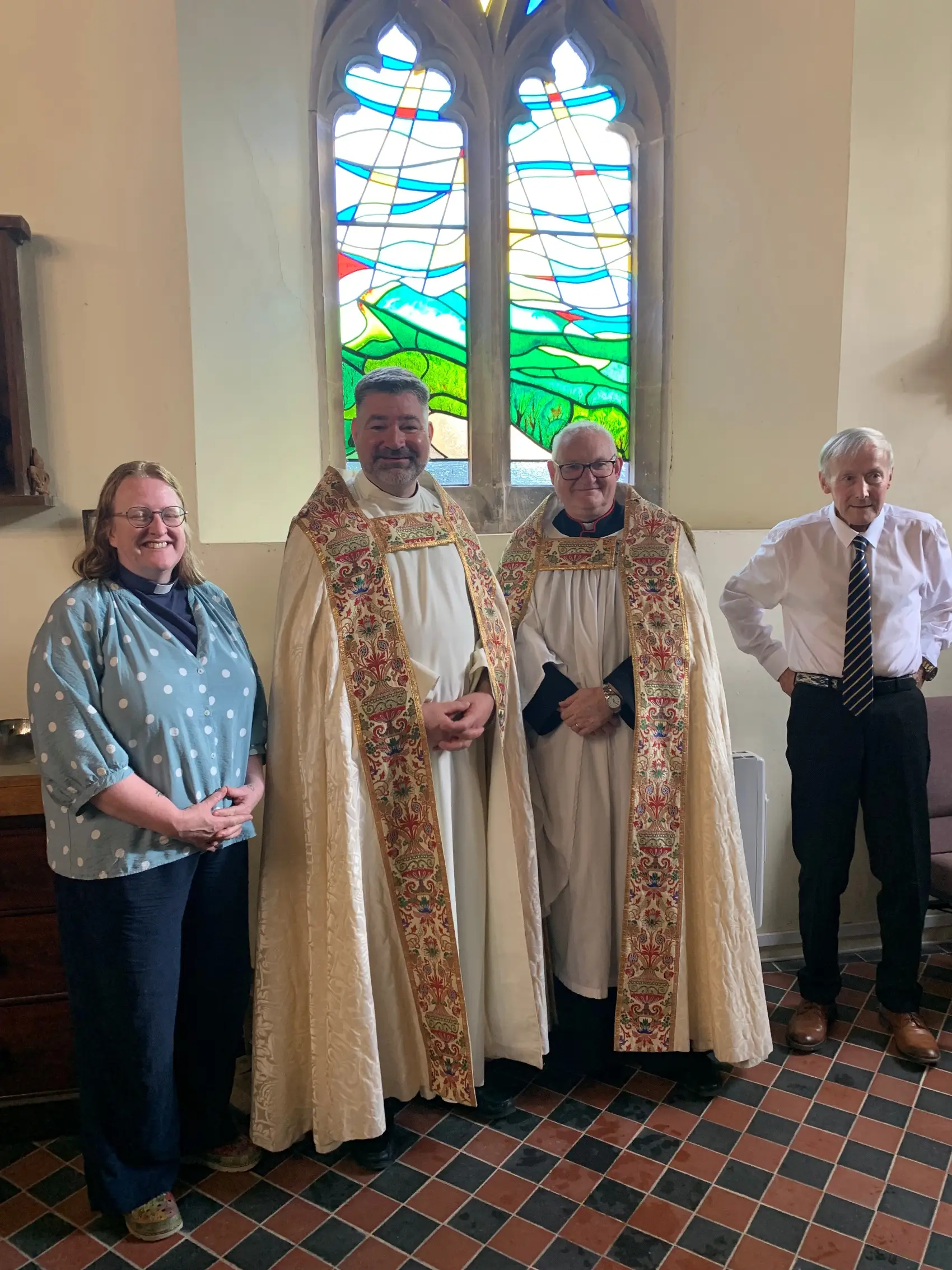 The vicar, Kat Mepham, Dean Stephen, Archdeacon Mark and another gentleman stand in front of the windrow