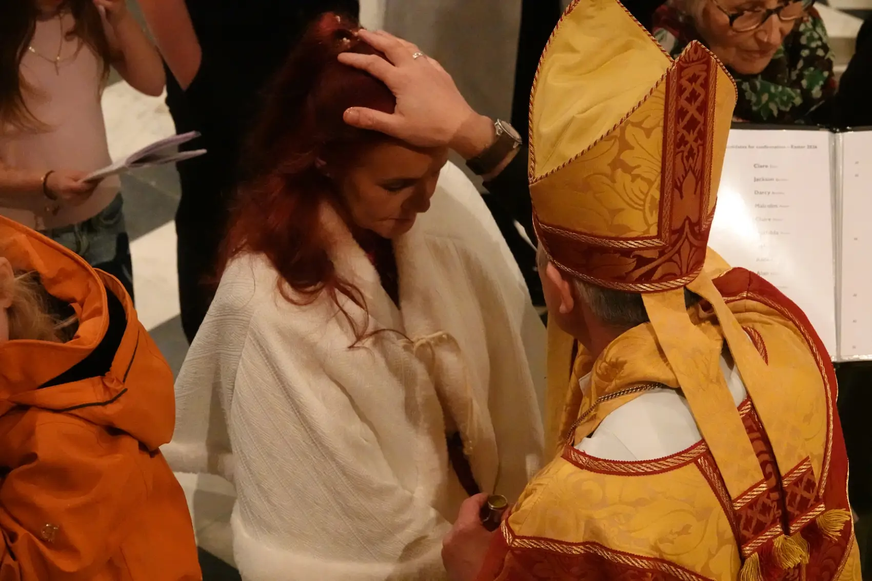 Bishop Hugh confirms Ruby by placing his hand on her head