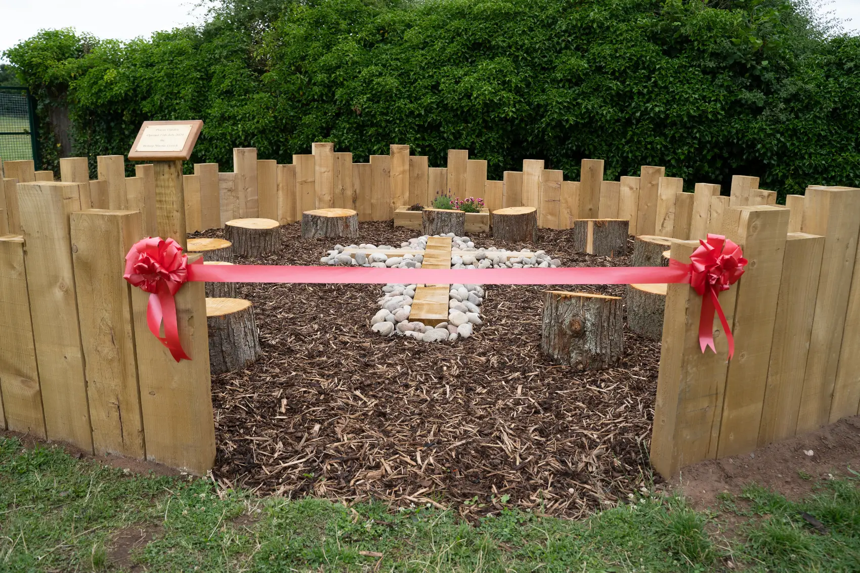 Prayer garden with a red ribbon across the entrance
