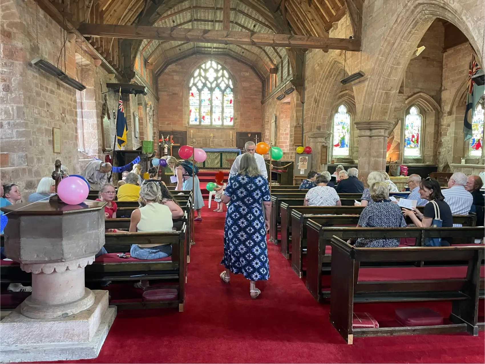 A view of Broadwas church decorated with balloons from the back of church