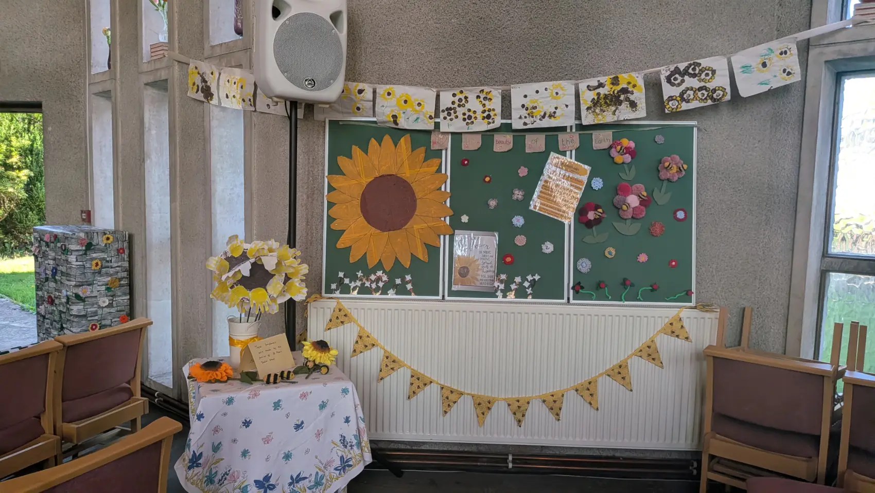 Creative display of sunflowers made mainly from paper and card