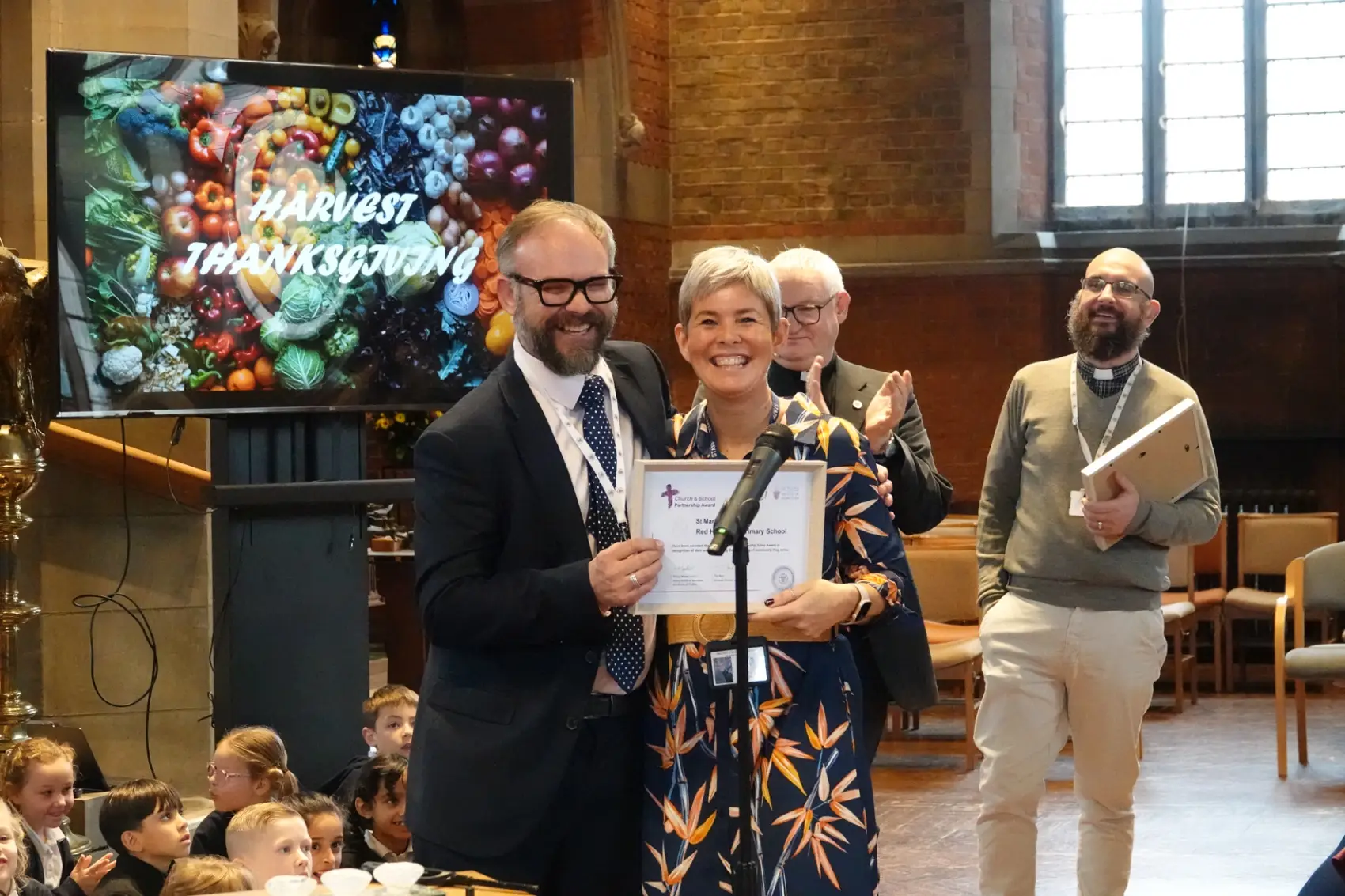 Tim Reid presenting Jolanda Simmonds with the church and School partnership award