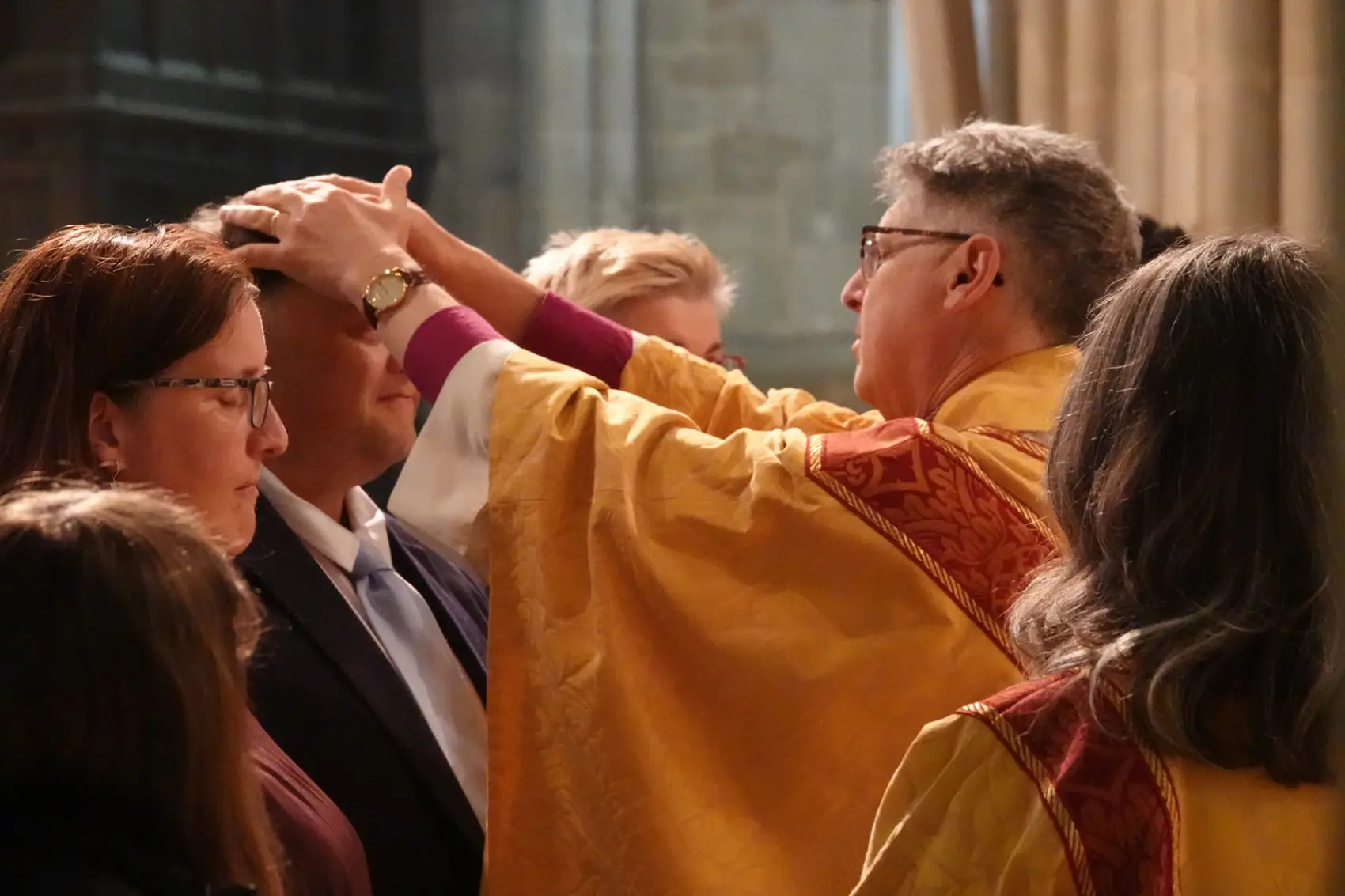Bishop Martin with his hands on the head of Richard Wood as he confirms him