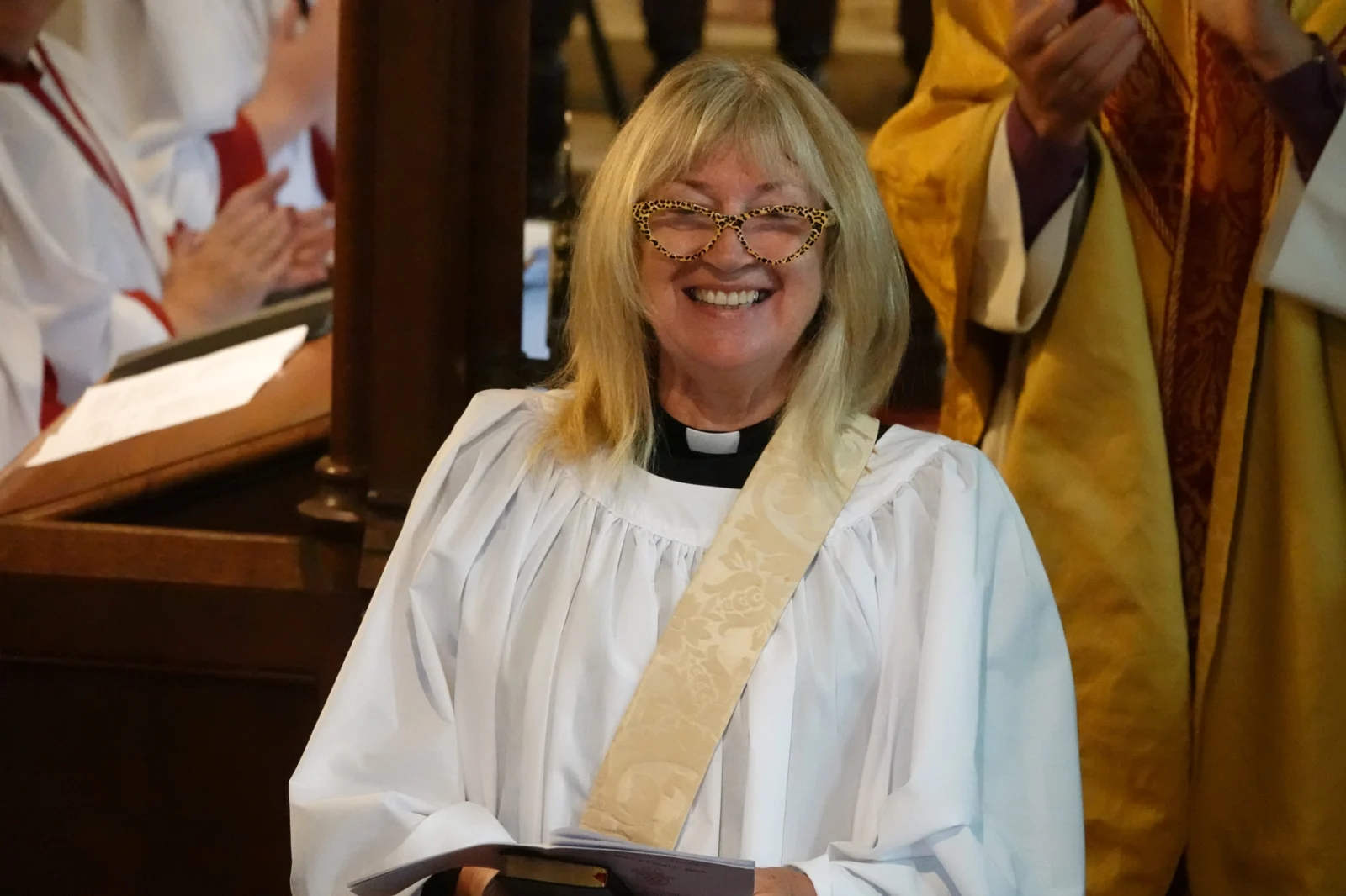 Head and shoulders photo of Penny Gordon standing at the front of Wick Church after her ordination as Deacon